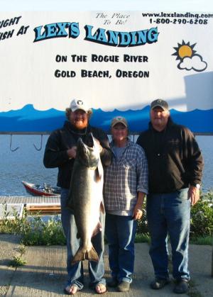Anglers showcasing a large fish they caught.