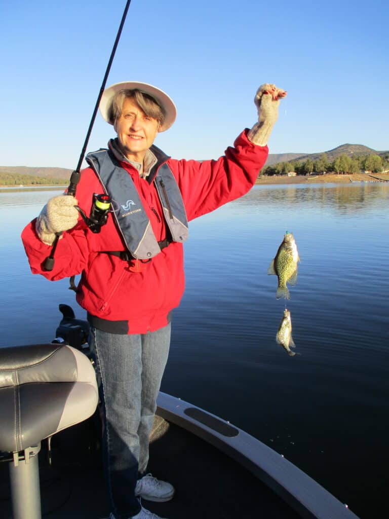 An angler sshowcasing two crappie on one line caught at prineville reservoir.