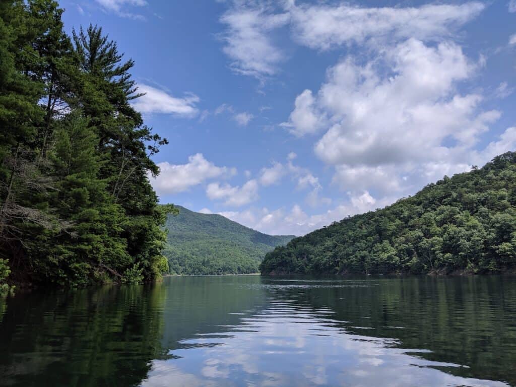 Scenic view of calm water of Switzer Lake surrounded by tree-covered shoreline.
