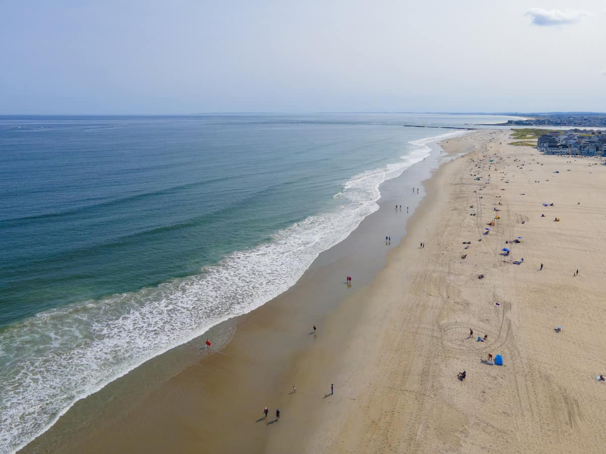 Aerial photo down Hampton Beach with the jetty in the far background marking a good striper fishing spot.